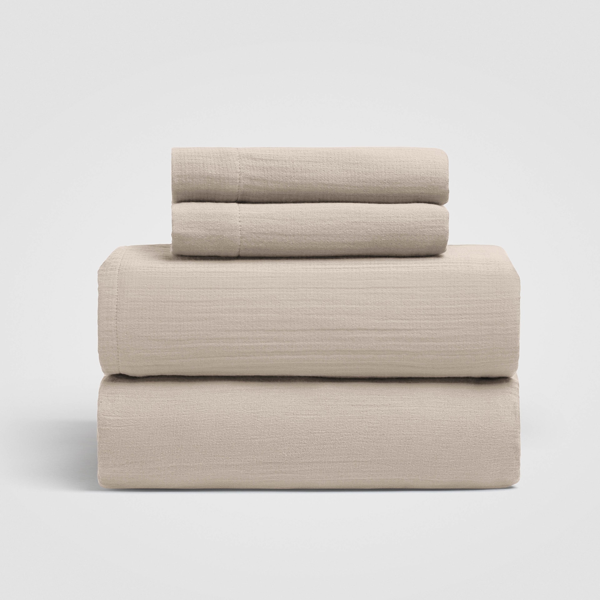 Stack of light beige sheets arranged on a white background