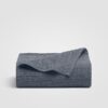 Blue flat sheet folded up on white background