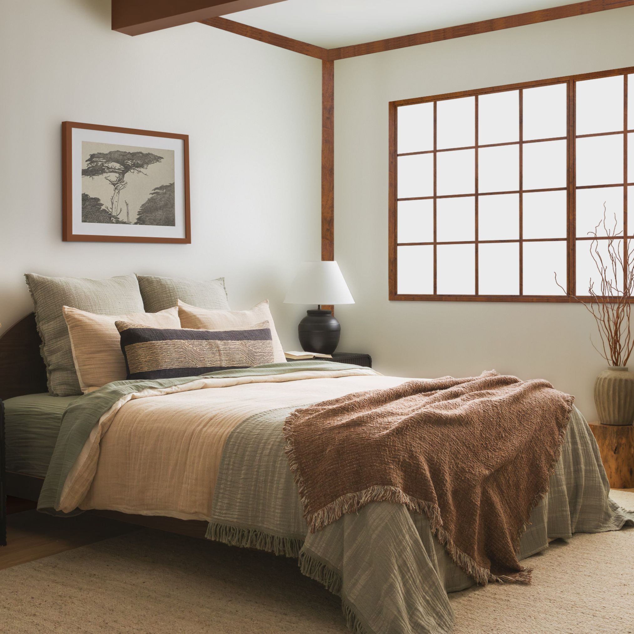 Bedroom with neutral bedding, rust-colored throw, and large windows with natural light