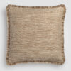Tan pillow with a fine woven fabric and dark piping on the edges