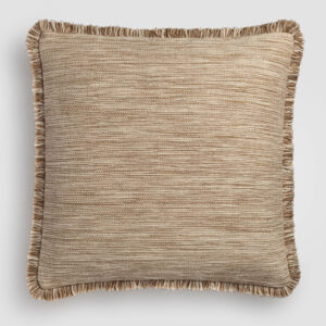 Tan pillow with a fine woven fabric and dark piping on the edges