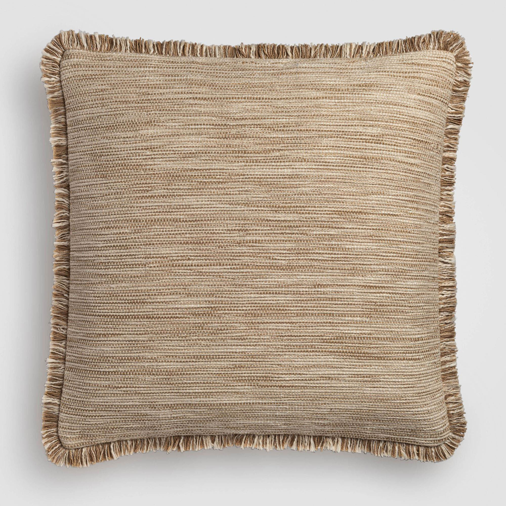 Tan pillow with a fine woven fabric and dark piping on the edges