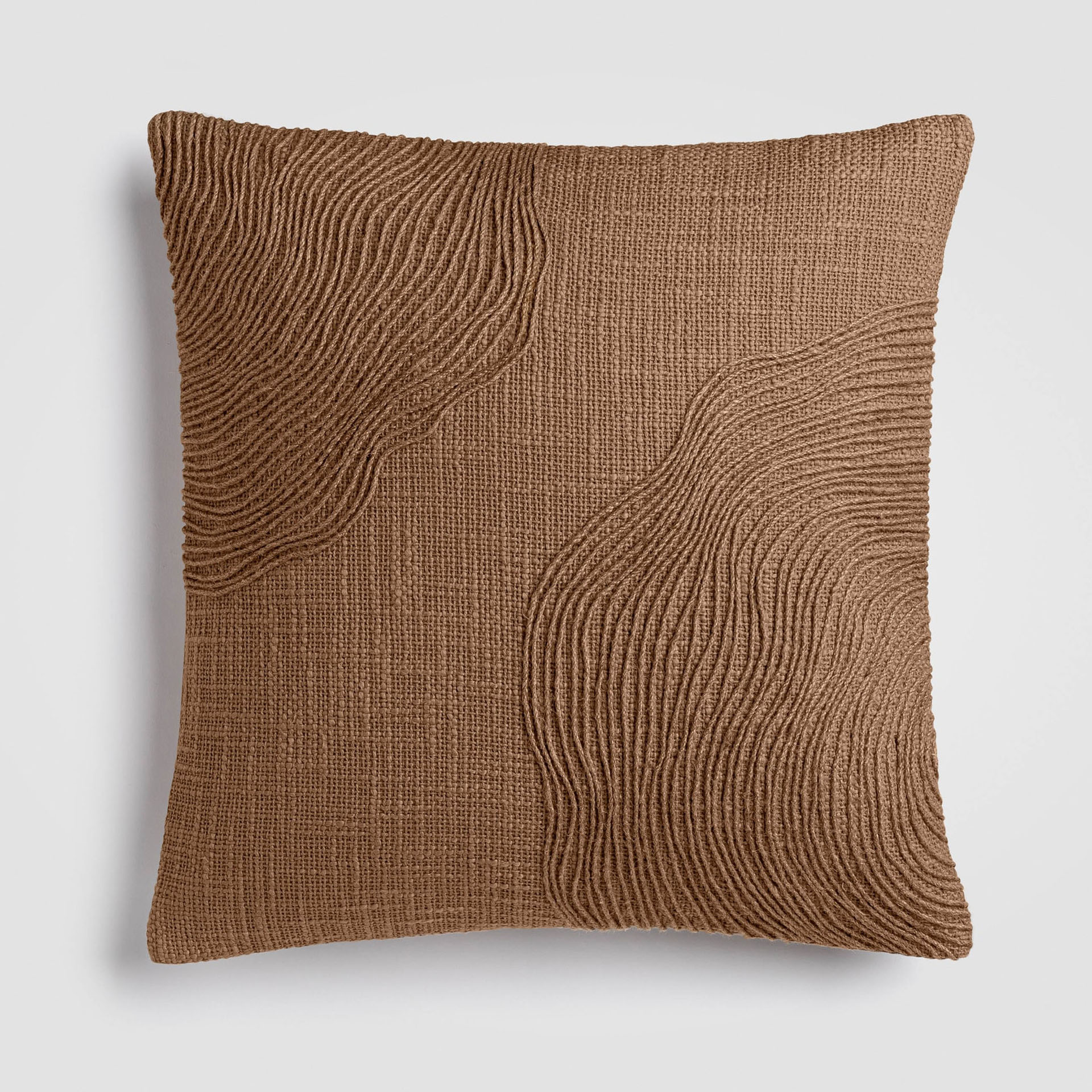 Rich rust-brown pillow with visible textured weave