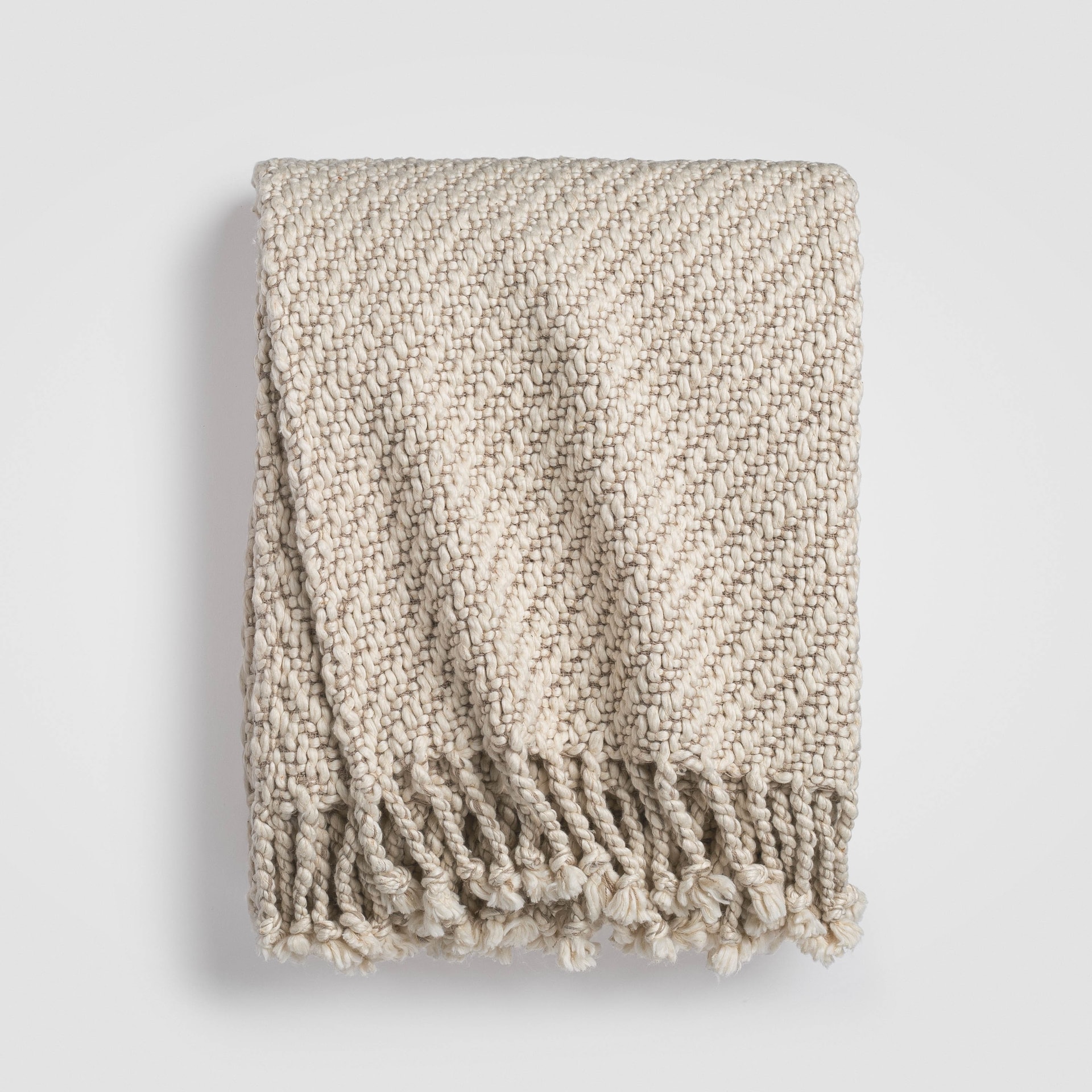 CH-200TH-2_(1)_HERO Folded beige knit throw blanket with textured stitching and soft drape