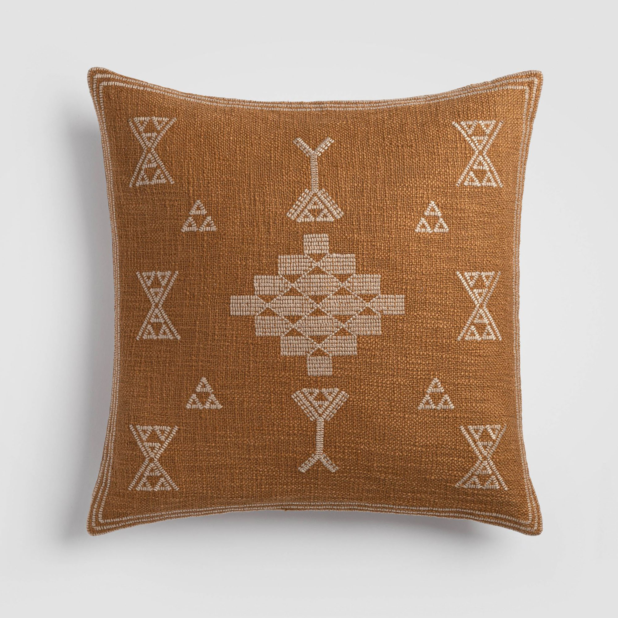 CH-210DP-2_(1)_HERO Burnt orange pillow with white tribal-inspired embroidered symbols