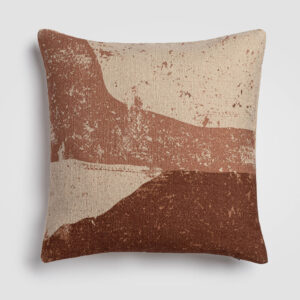 Square pillow with abstract diagonal blocks of terracotta, beige, and blush tones