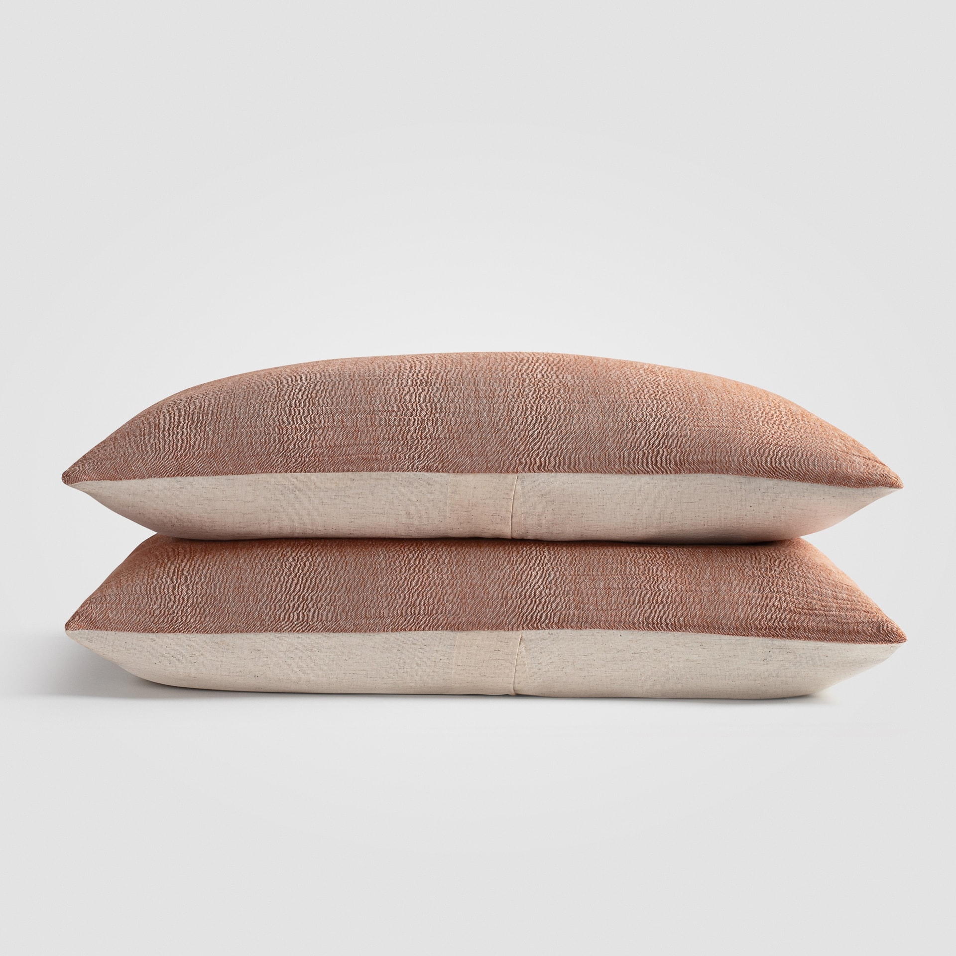 Folded blush pink knit throw blanket on a white background