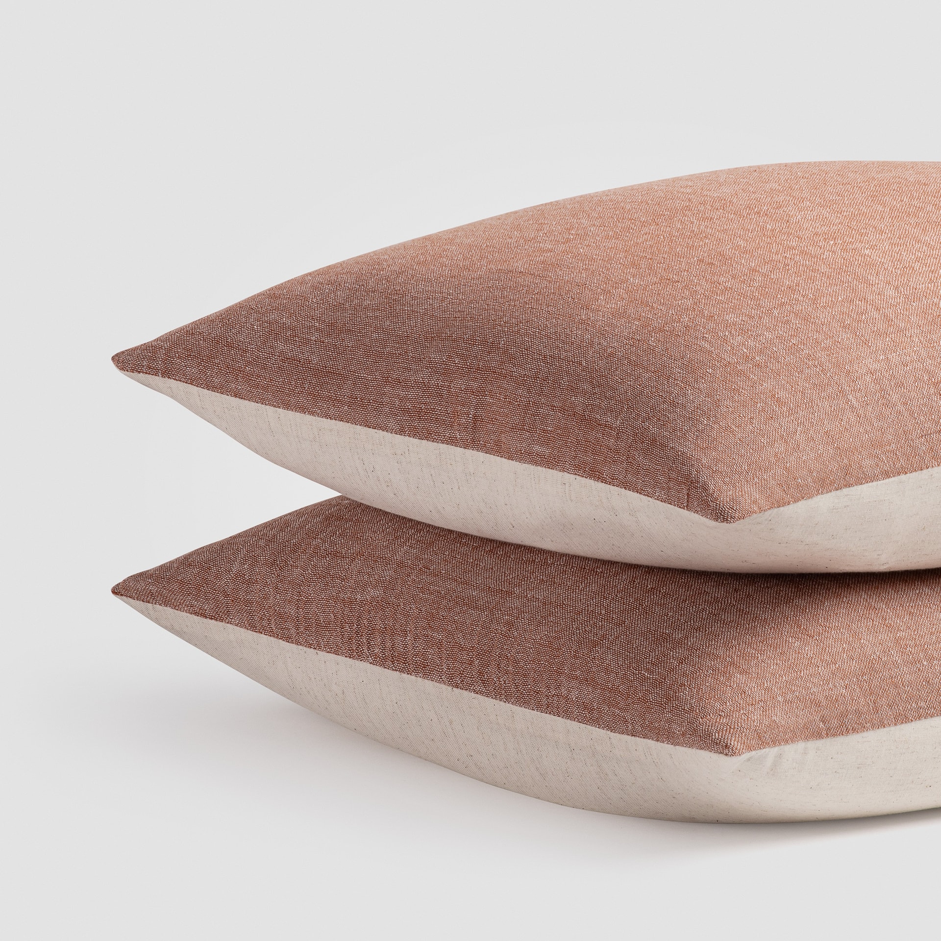 Close-up of two folded blush pink knit throws stacked on top of each other