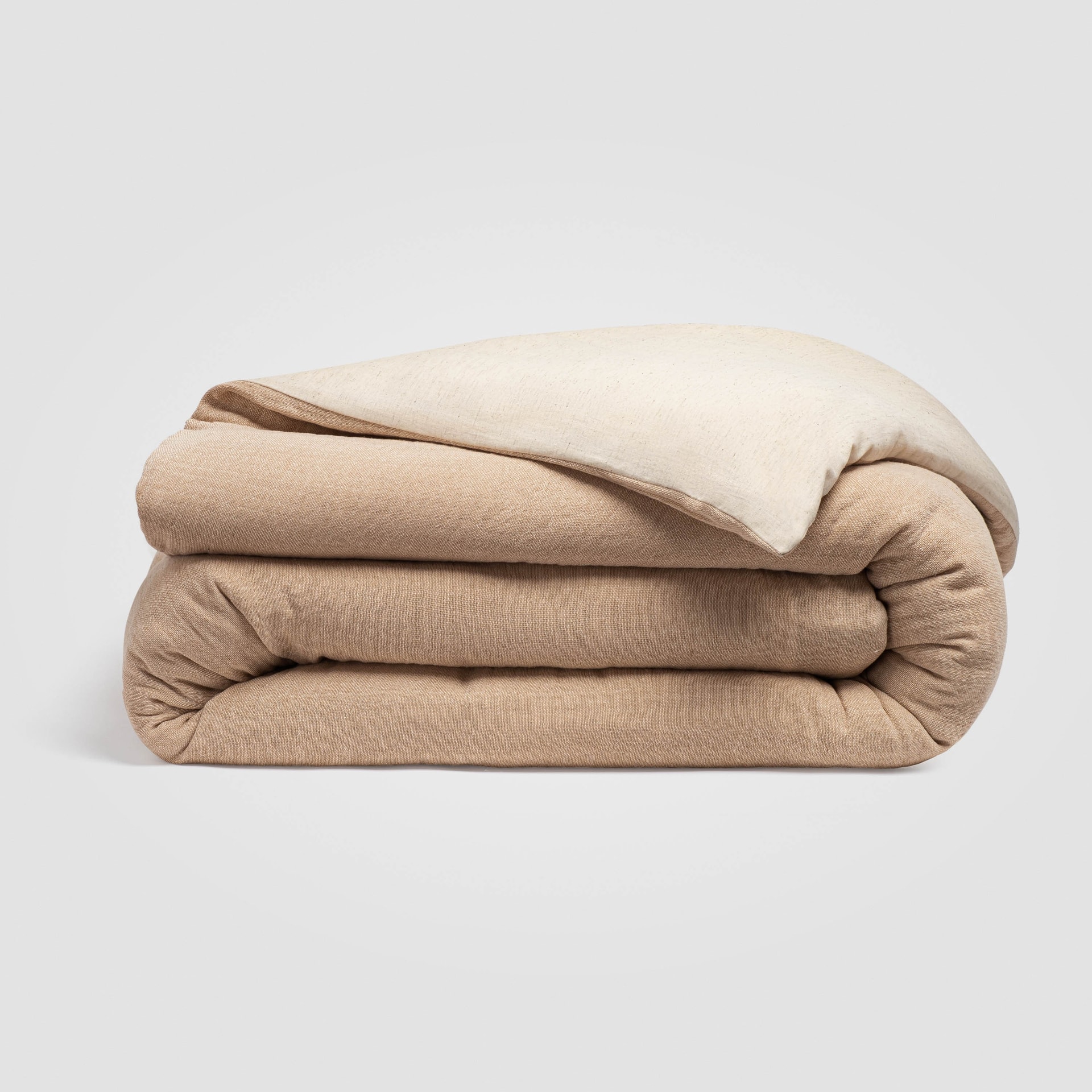 Folded rust-colored duvet cover on a plain white surface