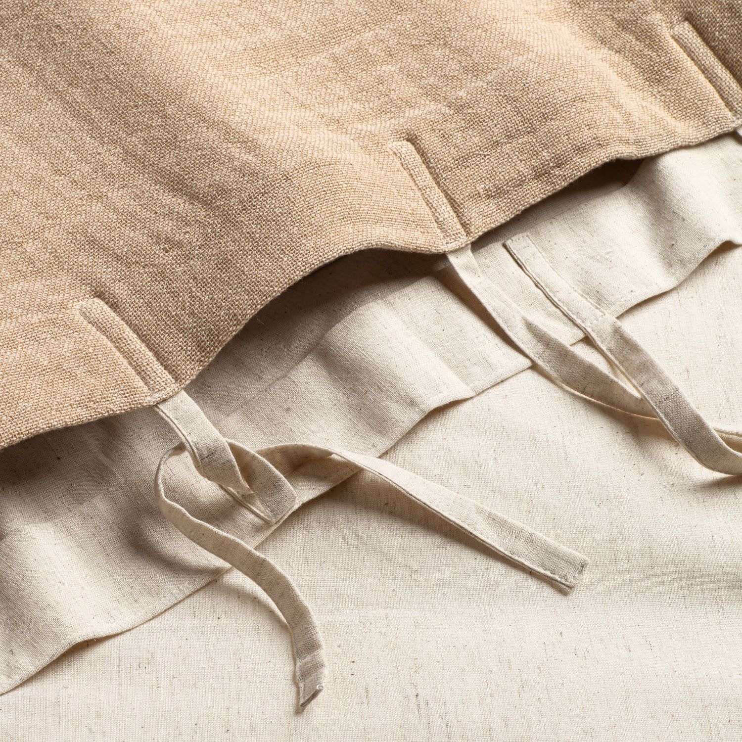 Close-up of white duvet cover with subtle seam detail and gathered fabric