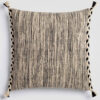 Cream pillow with a vertical stripe of thick black and gray stitching