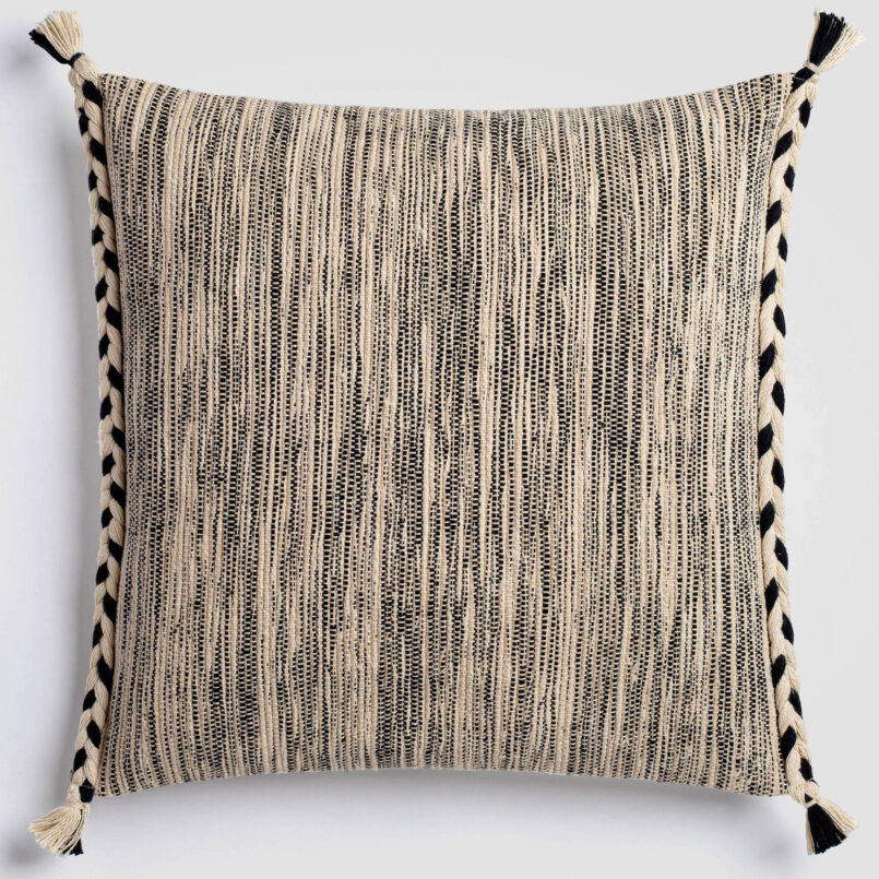 Cream pillow with a vertical stripe of thick black and gray stitching