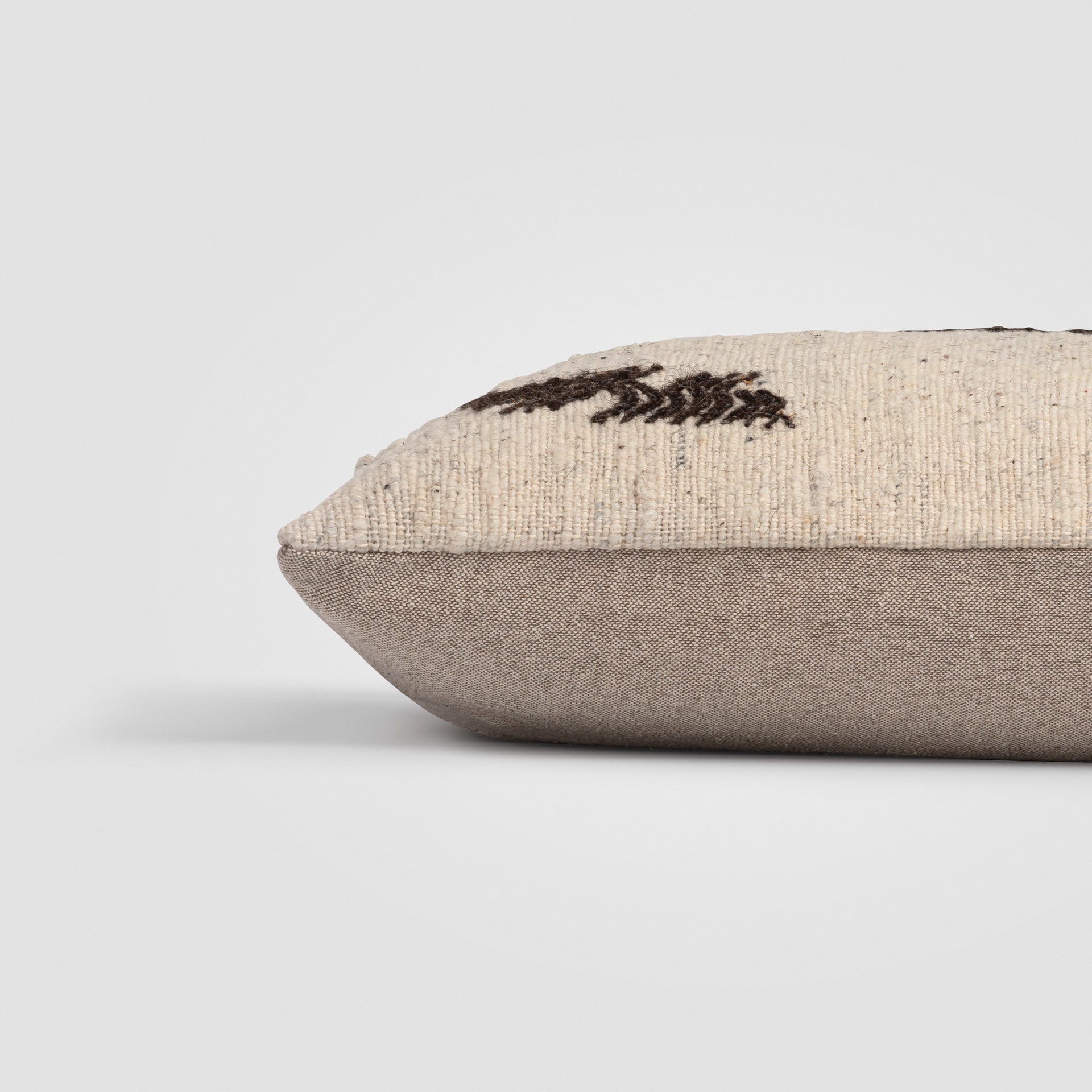 Beige pillow with horizontal woven stripe and subtle texture