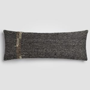Rectangular pillow with color block design in beige and soft rust with visible weave texture