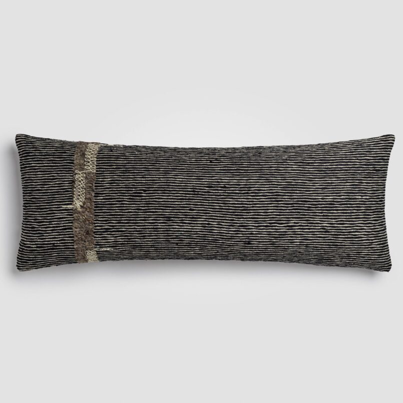 Rectangular pillow with color block design in beige and soft rust with visible weave texture