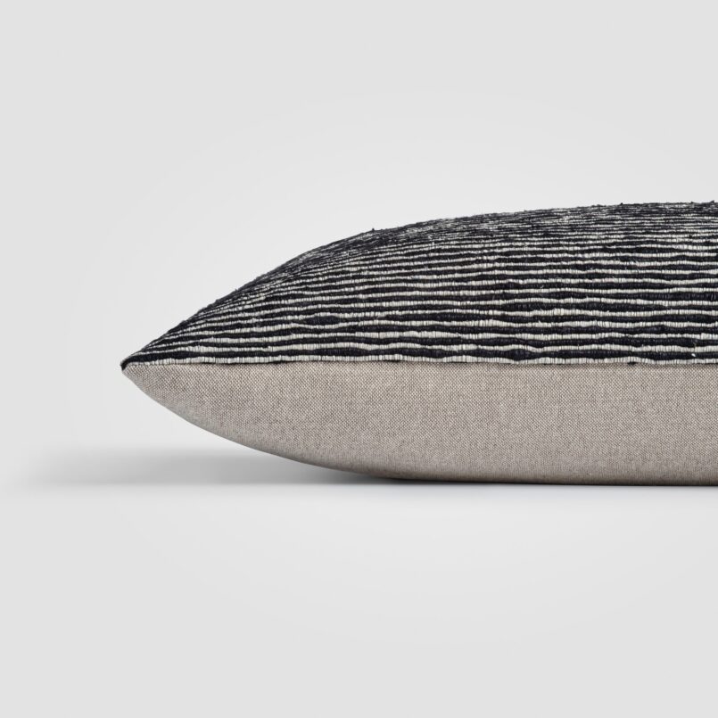Rectangular pillow with speckled black and white weave and thick center stripe