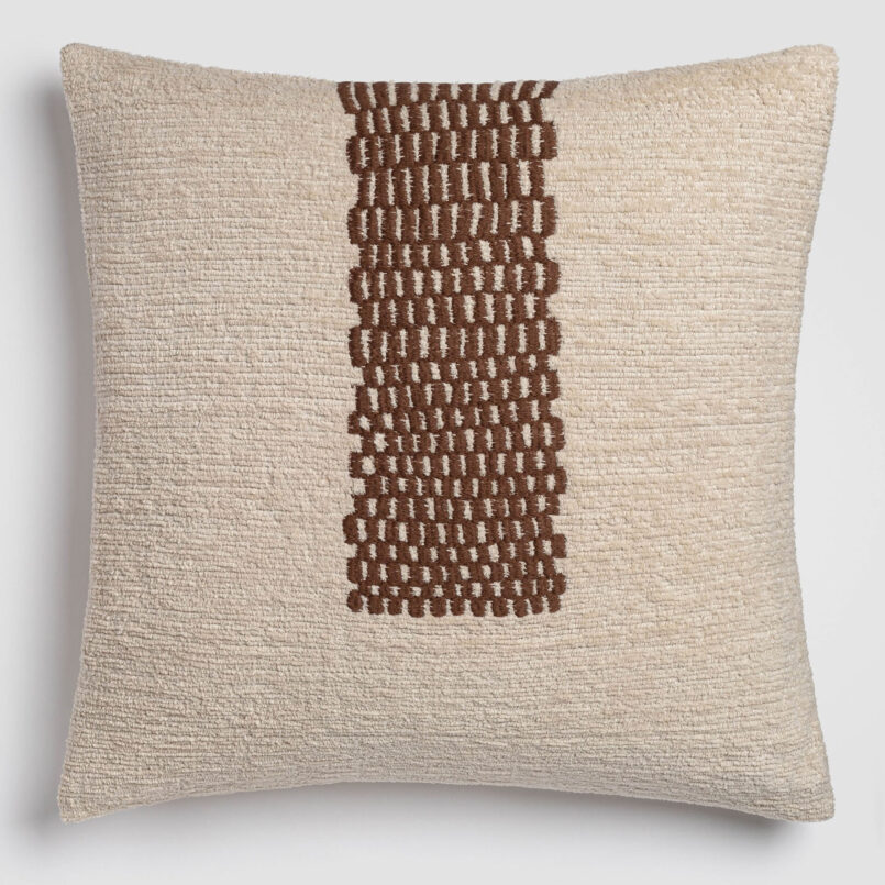 Beige pillow with a central vertical brown stitched detai