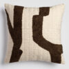 Cream pillow with large, bold abstract brown and black shapes