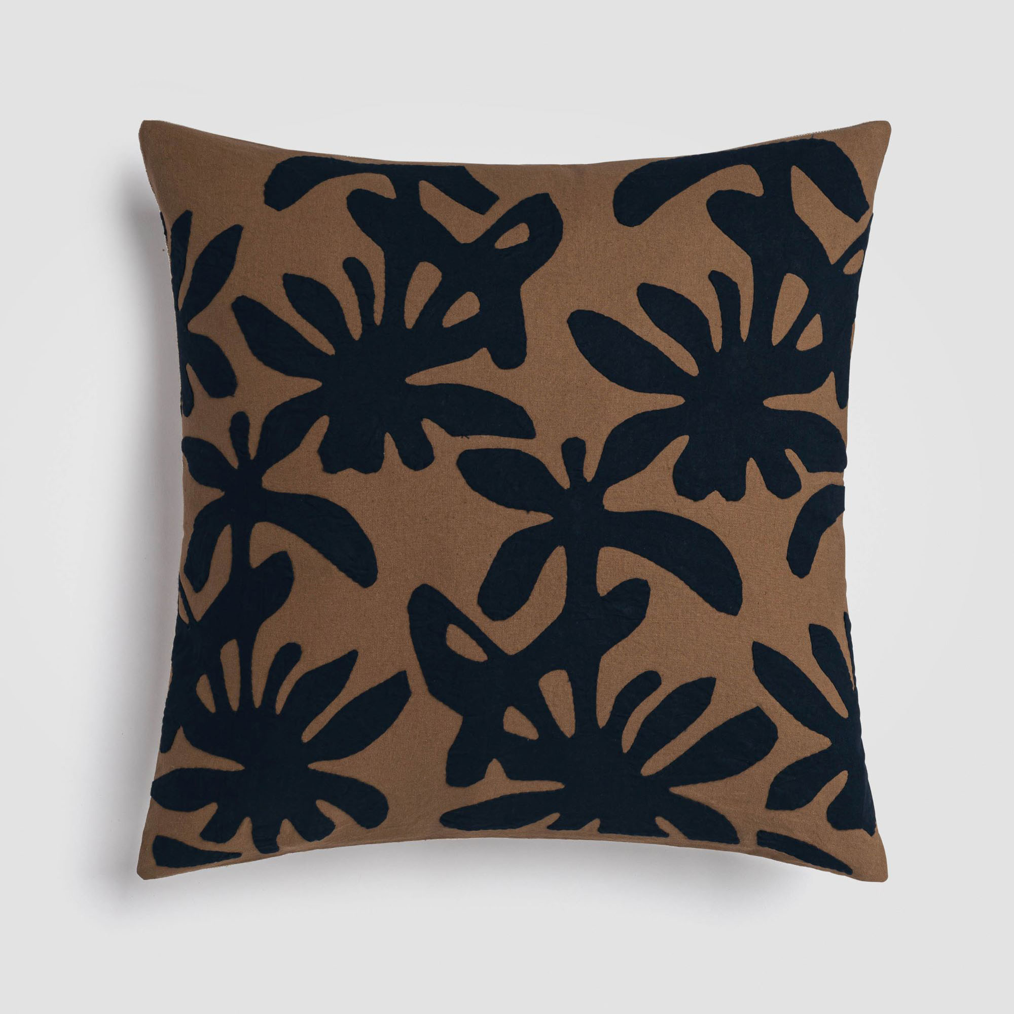 CH-230DP-2_(1)_HERO Dark blue pillow with a brown botanical leaf pattern on the front