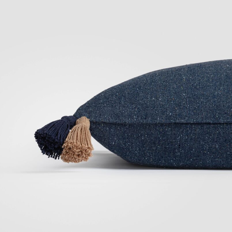 Side view of a dark navy pillow with visible textured weave