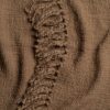 Close up of a beige throw blanket