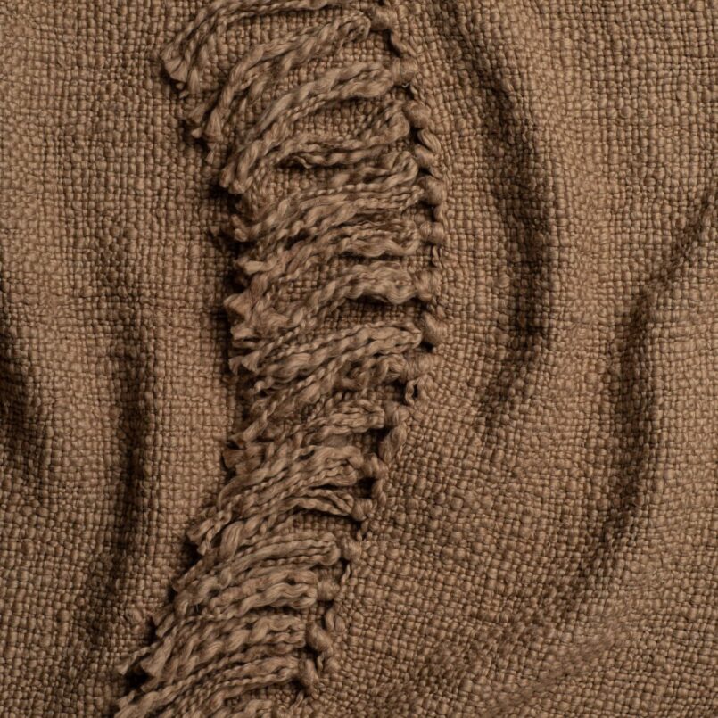 Close up of a beige throw blanket