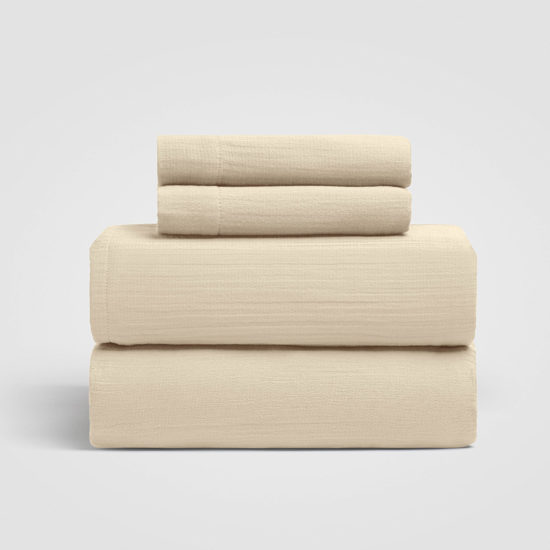 CH-210SS_(1)_HERO Set of three folded beige sheets stacked on a white background