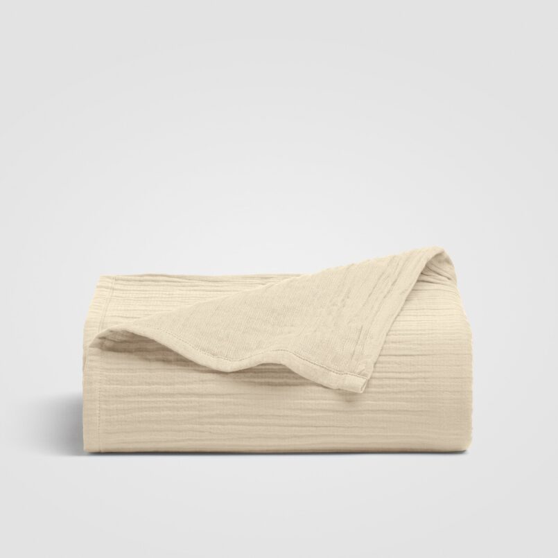 Cream-colored sheet with a subtle stitched design on a white background