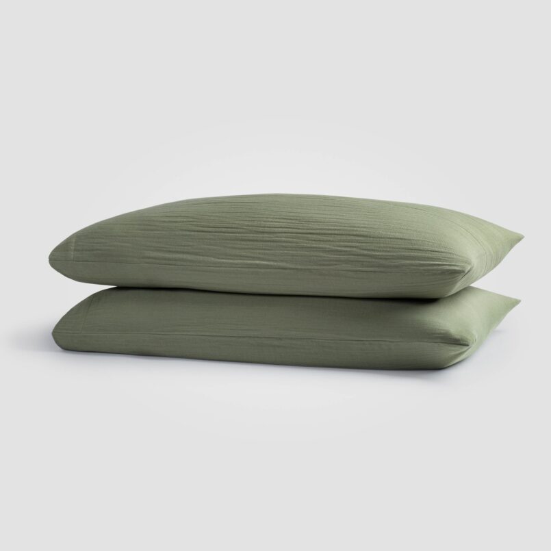 two green pillows stacked on eachother