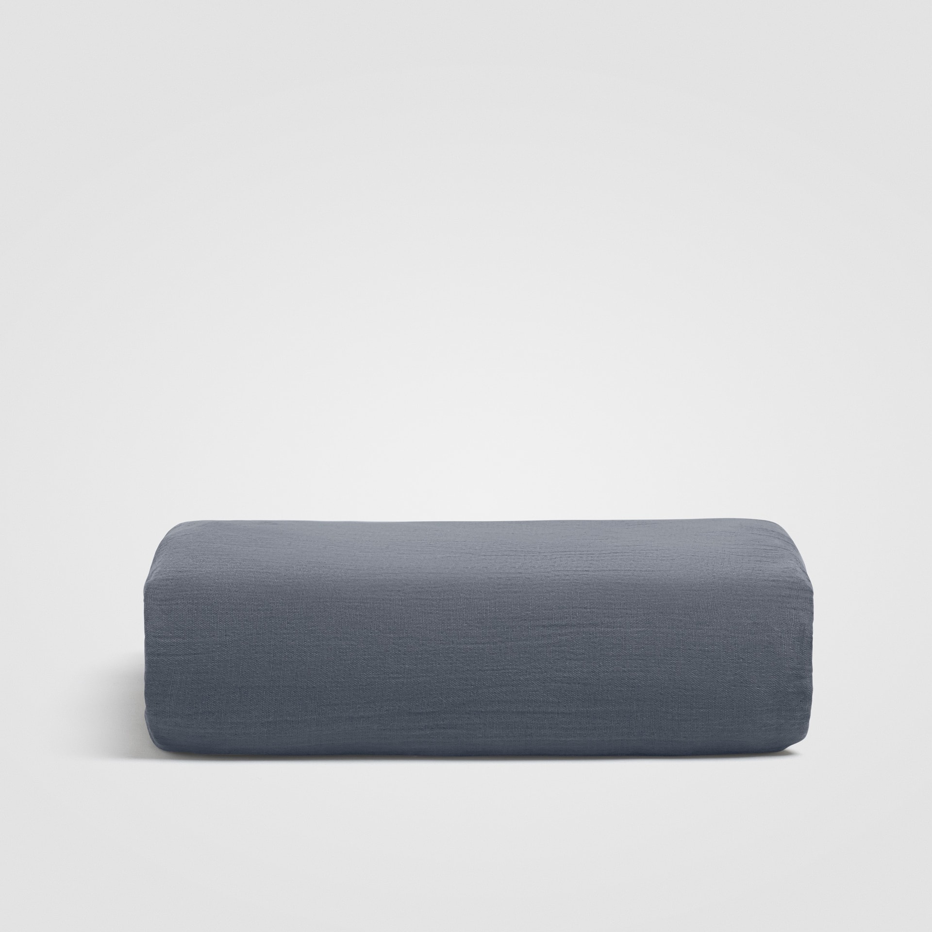 Rolled dark blue sheet on a plain white background