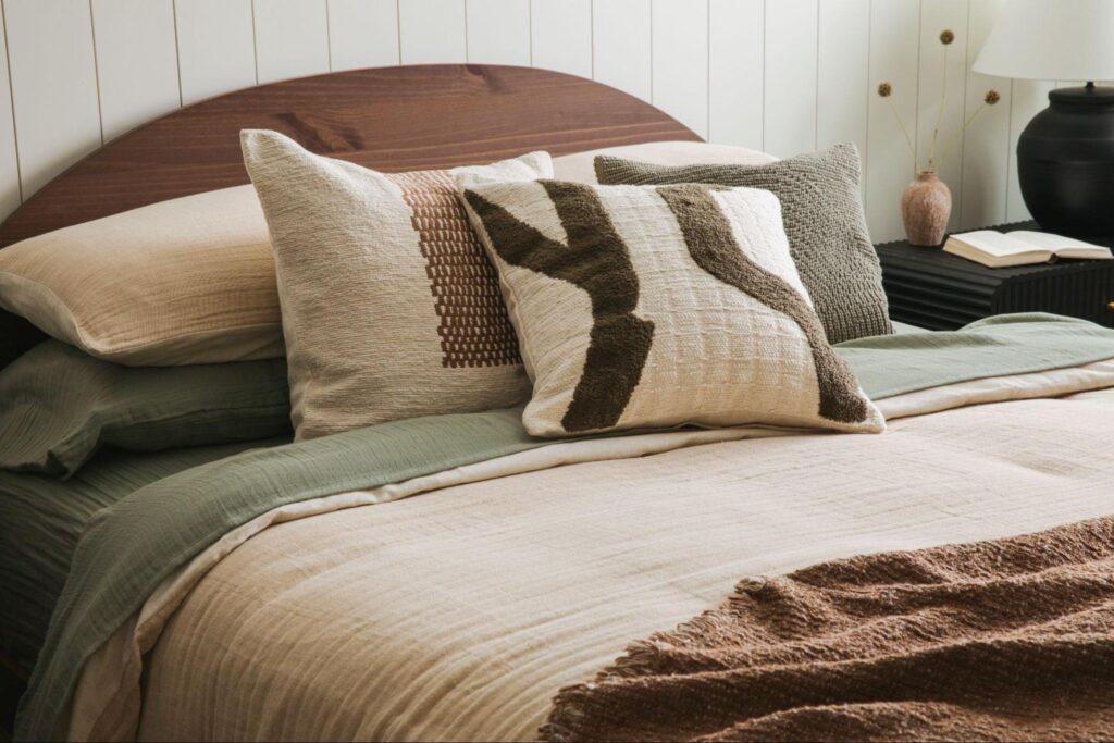 Bed decorated with green and brown bedding