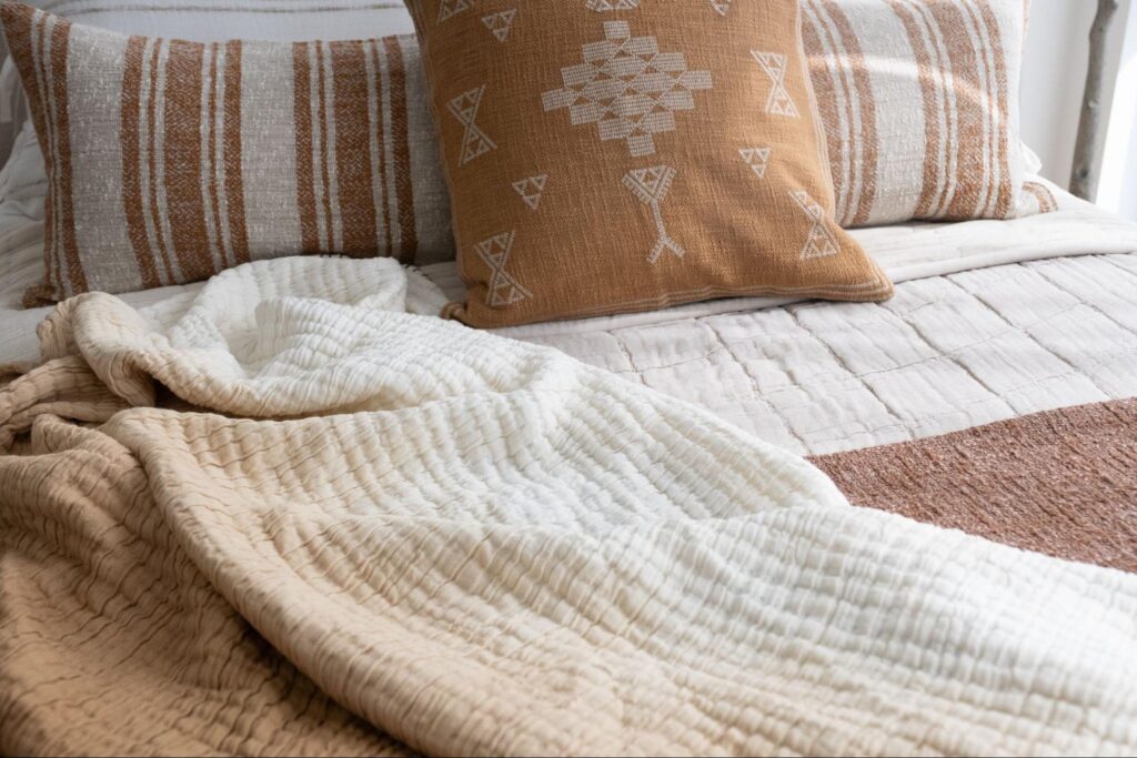 Ombre throw blanket draped over a bed