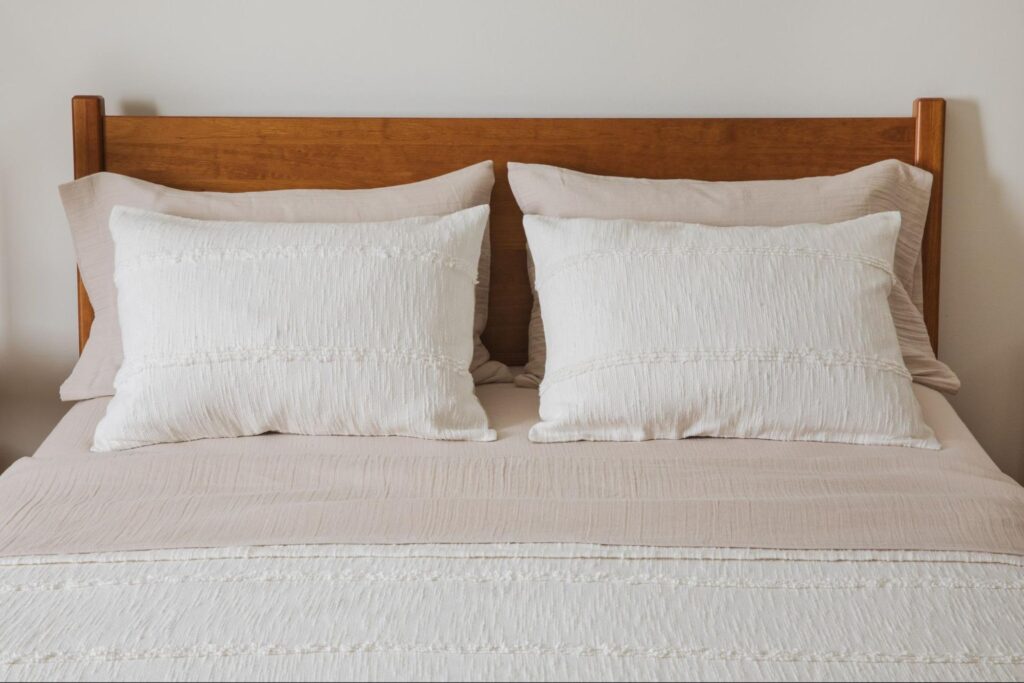 Bed with beige and white bedding