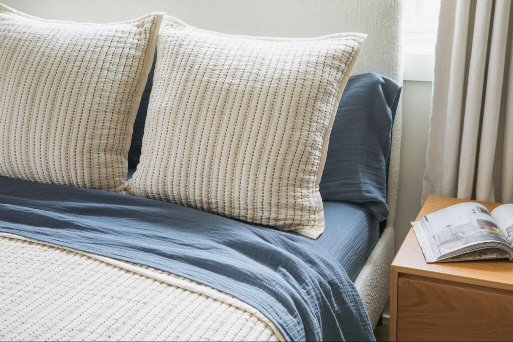 Striped pillows over blue bedding