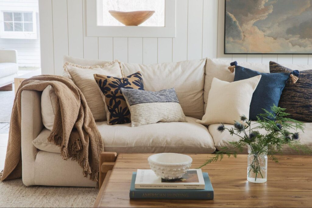 Living room couch with decor pillows and a throw
