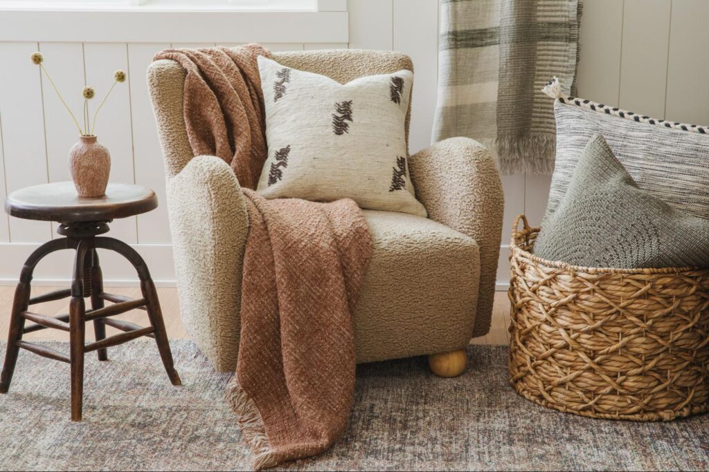 Arm chair with a throw blanket and pillow